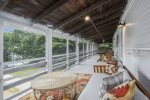 Upper level screen porch has three seating areas. There is a maximum occupancy on this porch of 5 people.